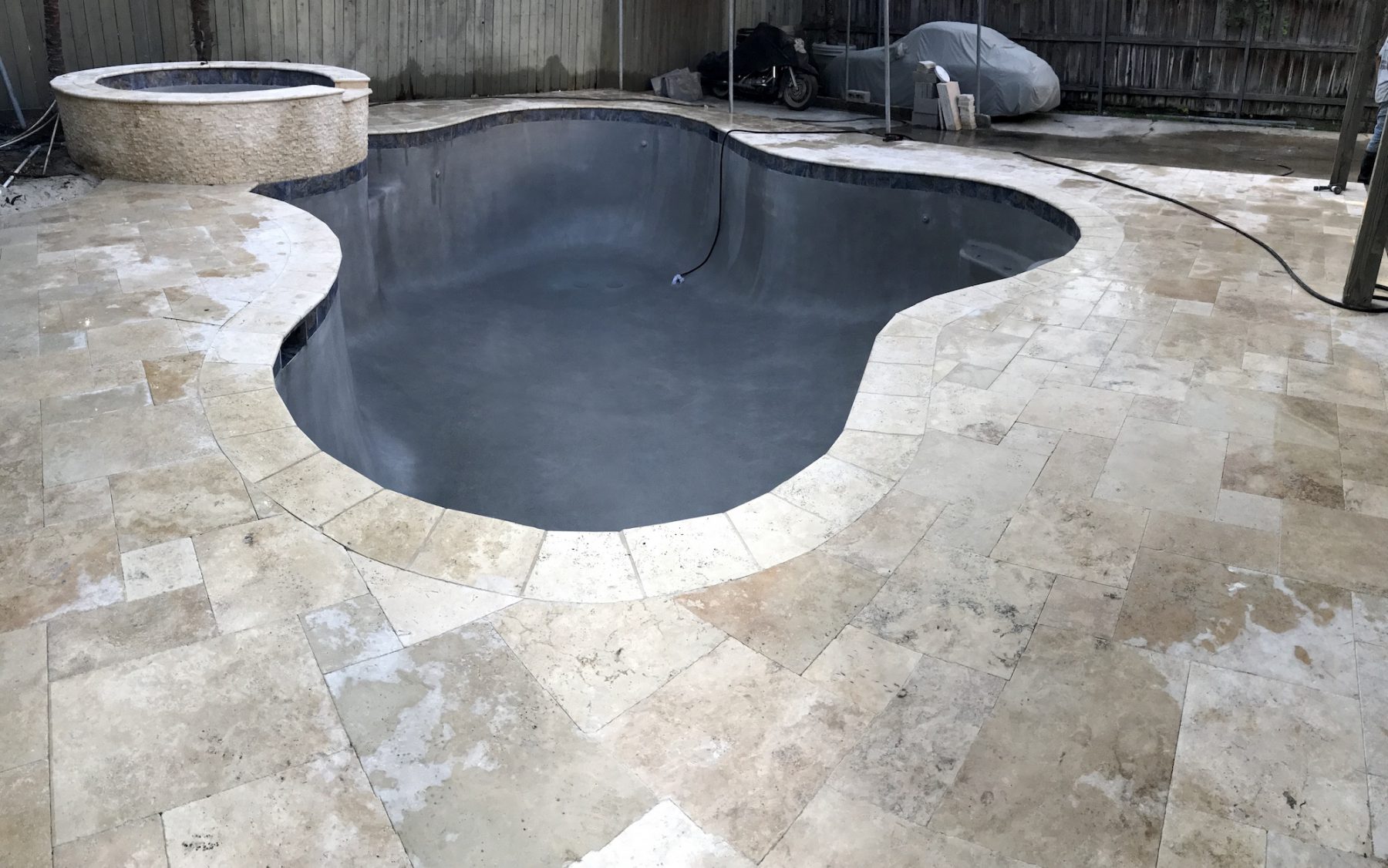 New Orleans Pool Repair project with Concrete deck removed and french pattern travertine pavers